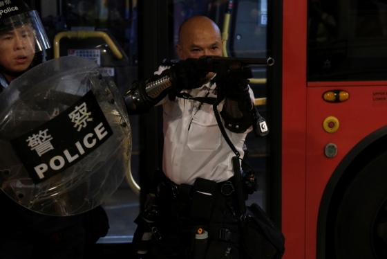 한 경관이 콰이청경찰서 앞에 모인 시위대를 향해 총을 겨누고 있다. 홍콩 경찰은 SCMP에 "그 경관이 흥분한 시위대에 둘러싸여 있었기 때문에 신변의 안전을 지키기 위해 총을 들어올린 것"이라며 "그 총에는 실탄이 아닌 콩알탄(beanbag rounds)이 들어 있었다"고 해명했다. /사진=로이터