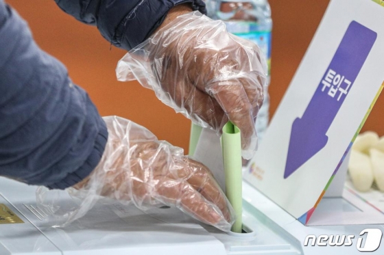 (서울=뉴스1) 성동훈 기자 = 제21대 국회의원 선거일인 15일 오전 서울 성북구 북한산국립공원 탐방안내소에 마련된 정릉4동 제4투표소에서 유권자들이 투표용지를 투표함에 넣고 있다. 중앙선거관리위원회에 따르면 이날 오전 9시 현재 전체 선거인 4399만4247명 중 353만7969명(잠정)이 21대 총선 투표에 참여해 총 8.0%의 투표율을 기록했다. 2020.4.15/뉴스1