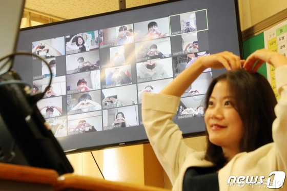 스승의 날을 하루 앞둔 14일 오전 경기도 성남시 분당구 운중중학교에서 온라인 쌍방향 수업 진행 중 학생들이 감사의 마음을 전하며 하트를 만들자 교사가 보답으로 머리 위로 하트를 만들고 있다./사진=뉴스1