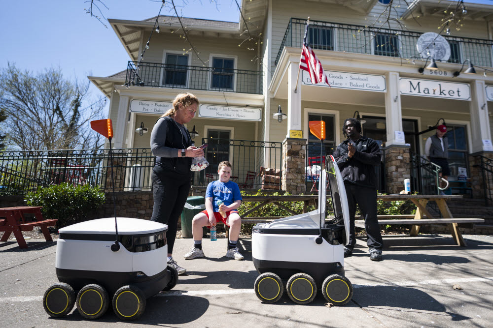 Food delivery robots, which eliminate the need for hand-to-hand delivery during the coronavirus COVID-19 pandemic, outside Broad Branch Market in Washington, DC, USA, 30 March 2020. Once loaded with a customerapos;s to-go order, the six-wheeled robots are fully autonomous, navigating sidewalks to the delivery address, and then returning to the market. EPA/JIM LO SCALZO