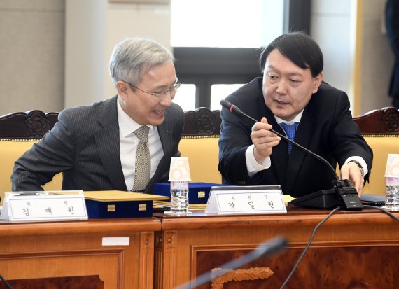 윤석열 검찰총장이 5일 오전 서울 서초구 대검찰청에서 열린 검찰인권위원회 위촉식에서 인사말을 마치고 강일원 검찰인권위원회 위원장에게 마이크를 옮겨주고 있다. 사진=박범준 기자