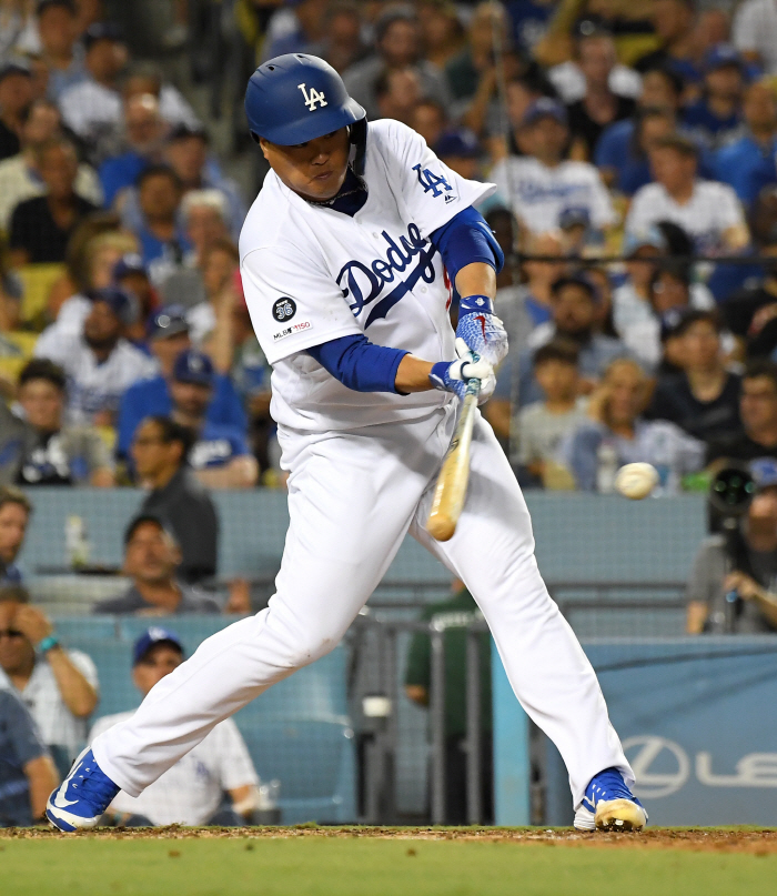 Sep 4, 2019; Los Angeles, CA, USA; Los Angeles Dodgers starting pitcher Hyun-Jin Ryu (99) singles in the fourth inning of the game against the Colorado Rockies at Dodger Stadium. Mandatory Credit: Jayne Kamin-Oncea-USA TODAY Sports