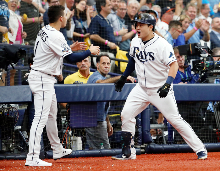 Oct 7, 2019; St. Petersburg, FL, USA; Tampa Bay Rays first baseman Ji-Man Choi (26) celebrates with shortstop Willy Adames (1) after hitting a home run against the Houston Astros during the third inning in game three of the 2019 ALDS playoff baseball series at Tropicana Field. Mandatory Credit: Kim Klement-USA TODAY Sports