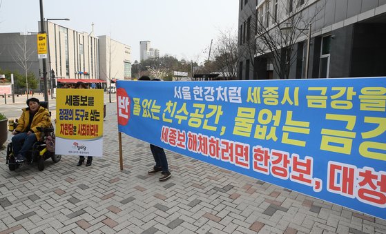 4대강 조사·평가 기획위원회의의 세종보 철거 발표에 대해 찬반 논란이 가열되고 있는 가운데 19일 세종시 한솔동 주민자치센터에서 환경부 주최로 열린 세종보 처리방안 공청회장 앞에서 찬반 단체가 함께 서서 각자의 논리를 알리고 있다. [연합뉴스]