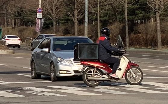 신호를 무시하고 횡단보도를 질주하는 배달 오토바이가 적지 않다. [중앙포토]