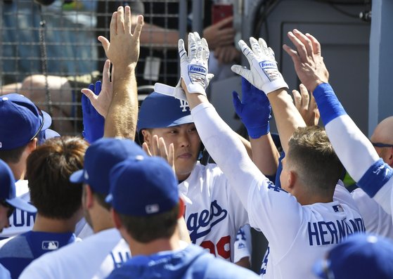 22일 메이저리그 첫 홈런을 치고 덕아웃으로 돌아온 류현진을 동료선수들이 축하하고 있다. [AFP=연합뉴스]