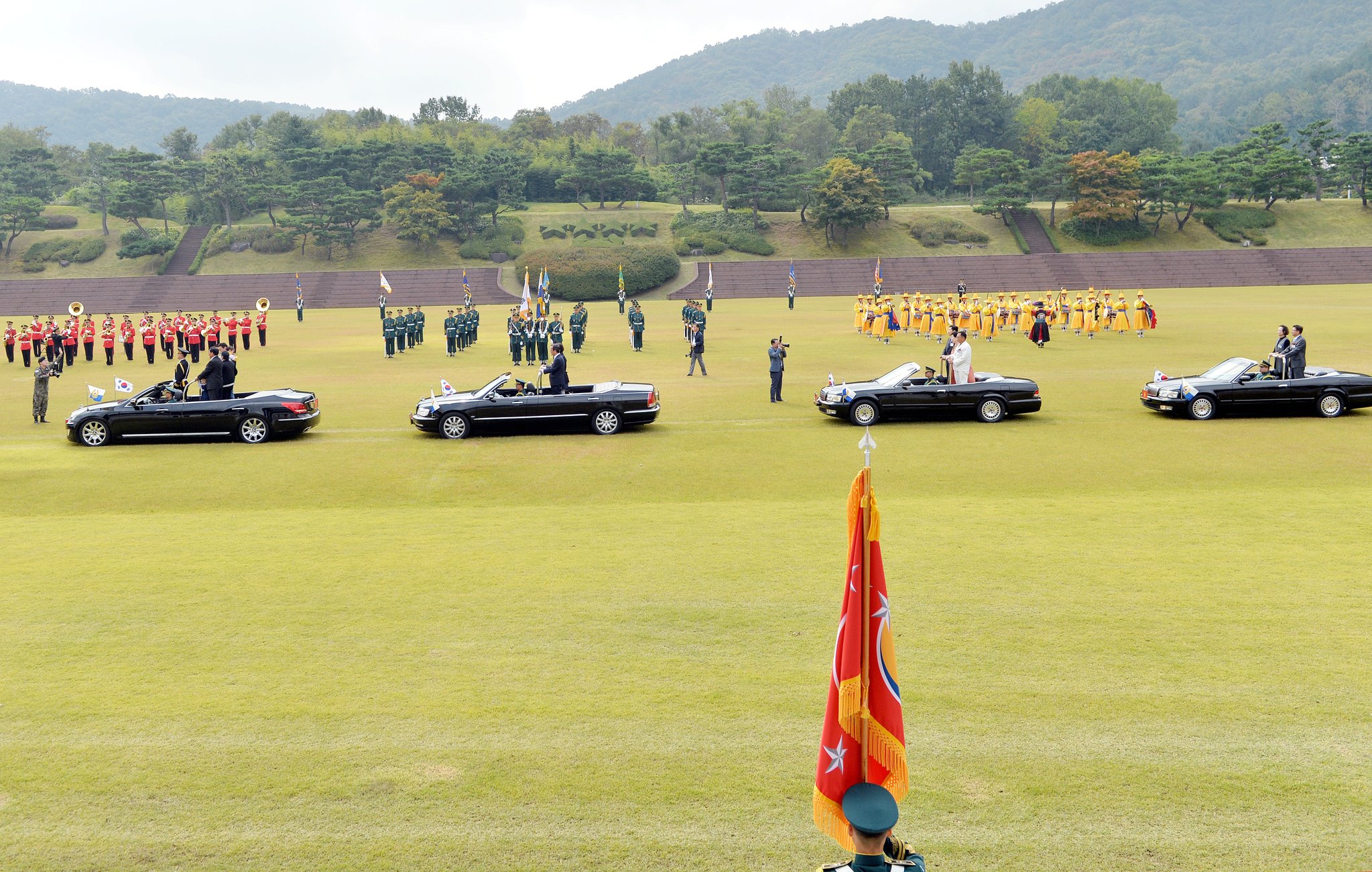 무공훈장을 받은 김두식 예비역 중령과 백금봉 예비역 하사와 가족, 고 민경호 하사, 최안 병장, 공상렬 병장, 이해영 일병의 유족들이 무개차를 타고 열병하고 있다. 프리랜서 김성태