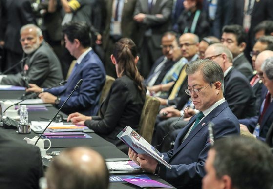 ASEAN+3 정상회의 참석차 싱가포르를 방문 중인 문재인 대통령(오른쪽)이 15일 오후 센텍 회의장에서 열린 동아시아 정상회의(EAS)에 참석해 리센룽 싱가포르 총리의 모두발언을 듣고 있다. 한 자리 건너 아베 신조 총리가 보인다. [청와대사진기자단]
