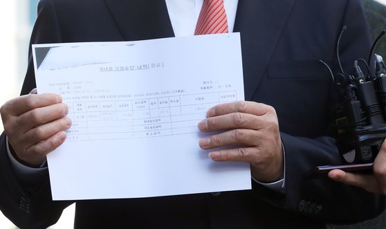 김성태 한국당 의원이 지난해 11월 핵심 증거인 여의도 일식집 만찬 영수증을 취재진에 보여주고 있다. 영수증에는 2011년에 만찬이 있었다는 서유열 전 KT 사장의 주장과 달리 2009년 5월 14일에 결재된 것으로 나와 있다. [뉴스1]