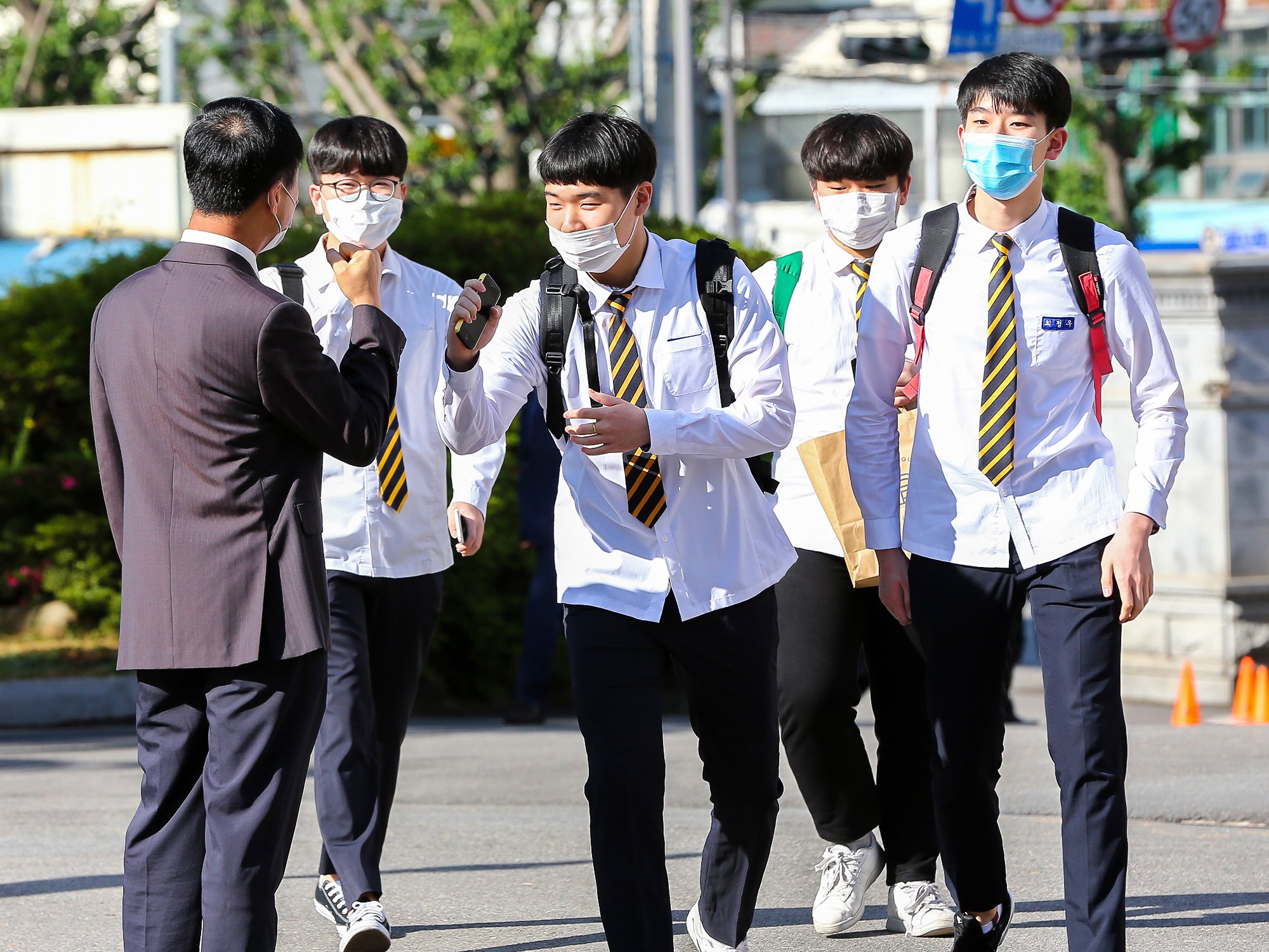 이날 광주시 동구 광주고등학교 3학년생들이 교문에서 만난 교사와 '주먹인사'를 나누며 교실로 향하고 있다. 프리랜서 장정필