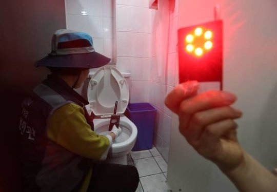 서울시 여성안심보안관이 청파동의 한 여성 화장실에서 전자파탐지기로 몰래카메라가 숨겨져 있는지 점검하고 있다. 김상선 기자