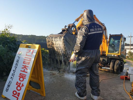 국내에서 처음으로 아프리카돼지열병(ASF) 발병한 경기 파주시 연다산동의 한 양돈농가 인근 통제초소에서 방역 당국 관계자들이 살처분 작업에 투입된 중장비에 대한 방역을 실시하고 있다./사진=유병돈 기자