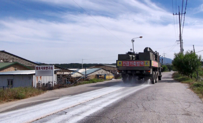 강원 철원군의 돼지농장 인근에서 군 제독차량이 아프리카돼지열병(ASF) 차단 방역 작업을 하고 있다. 연합뉴스 제공