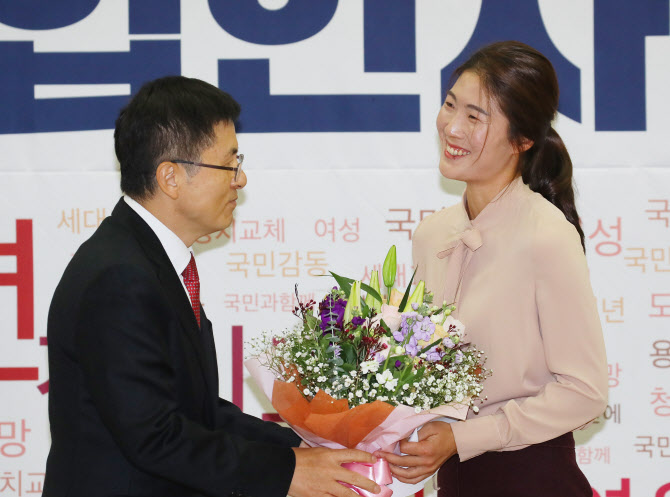 제21대 총선을 앞두고 자유한국당에 영입된 체육계 미투 1호인 김은희 씨가 8일 국회 의원회관에서 열린 한국당 영입인사 환영식에서 황교안 대표에게 꽃다발을 전달받고 있다.(사진 = 연합뉴스)