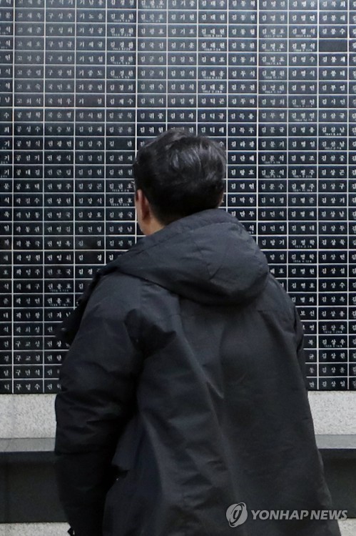 5·18  명단 살펴보는 시민(광주=연합뉴스) 천정인 기자 = 자유한국당 김진태 의원을 비롯해 일부 극우단체를 중심으로 5·18 유공자 명단을 공개하라는 주장이 제기되고 있는 가운데 17일 오후 광주 서구 5·18기념공원 내 추모공간에서 한 시민이 4296명의 5·18 피해자 명단을 살펴보고 있다. 2019.2.17 iny@yna.co.kr