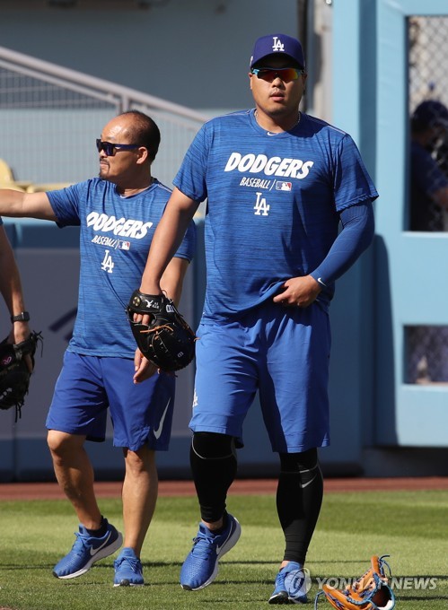 선발등판 D-2(로스앤젤레스=연합뉴스) 서명곤 기자 = '코리안 몬스터' 류현진이 4일(현지시간) 오후 로스앤젤레스 다저스타디움에서 열린 미국프로야구 메이저리그(MLB) 내셔널리그 디비전시리즈 2차전 LA 다저스와 워싱턴 내셔널스의 경기에 앞서 캐치볼을 한 뒤 김용일 전담 트레이닝 코치와 함께 더그아웃으로 향하고 있다. 2019.10.5 seephoto@yna.co.kr