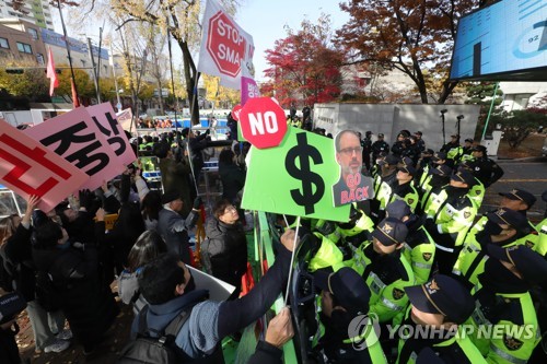 방위비 분담금 회의장 앞 경찰과 대치하는 시민단체(서울=연합뉴스) 류영석 기자 = 제11차 한미 방위비 분담금 특별협정(SMA) 제3차 회의가 열리는 18일 서울 동대문구 한국국방연구원 앞에서 평화와통일을여는사람들 회원들이 방위비분담 협상 중단을 촉구하는 기자회견을 마친 후 경찰과 대치하고 있다. 2019.11.18 ondol@yna.co.kr