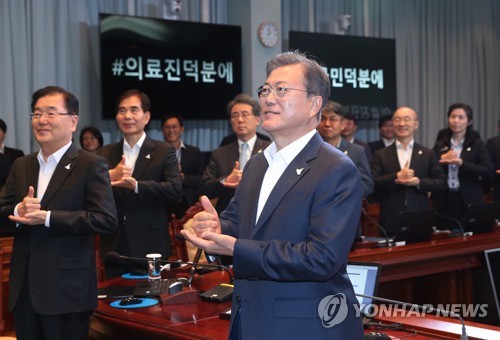 문재인 대통령이 4월 27일 오후 청와대에서 수석·보좌관 회의를  주재하기에 앞서 참석자들과 함께 신종 코로나바이러스 감염증(코로나19) 의료인에게 고마움을 전하는 '덕분에 챌린지'에 참여하고 있다. [연합뉴스 자료사진]