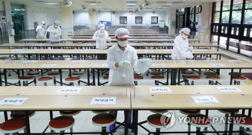 안전한 등교 수업을 위해(수원=연합뉴스) 홍기원 기자 = 초등학교 1, 2학년 등교수업을 이틀 앞둔 25일 오후 경기도 수원시 매여울초등학교 급식실에서 관계자들이 테이블과 칸막이 등을 소독하고 있다. 2020.5.25 xanadu@yna.co.kr