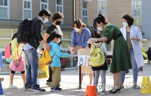'발열체크하는 유치원생'(세종=연합뉴스) 김주형 기자 = 신종 코로나바이러스 감염증(코로나19) 사태로 미뤄졌던 유치원과 초등학교 1∼2학년, 중학교 3학년, 고등학교 2학년의 등교 개학일인 27일 오전 세종시 연양유치원에서 어린이들이 입실 전 발열체크를 하고 있다. 2020.5.27 kjhpress@yna.co.kr