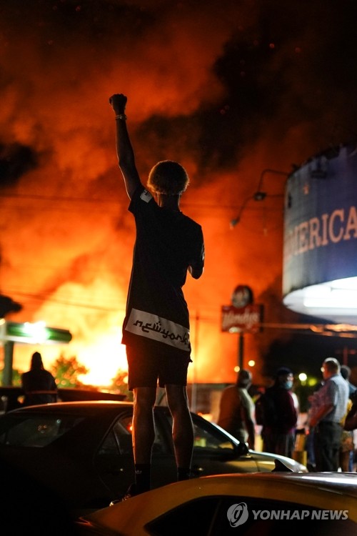불타는 웬디스 매장 인근에서 주먹 치켜든 시위대

(애틀랜타 AP=연합뉴스) 13일(현지시간) 흑인 남성 레이샤드 브룩스(27)가 경찰의 총격에 숨진 현장 인근인 미국 조지아주 애틀랜타의 웬디스 매장이 항의 시위로 불타고 있는 가운데 한 시위 참가자가 주먹을 치켜들고 있다. jsmoon@yna.co.kr