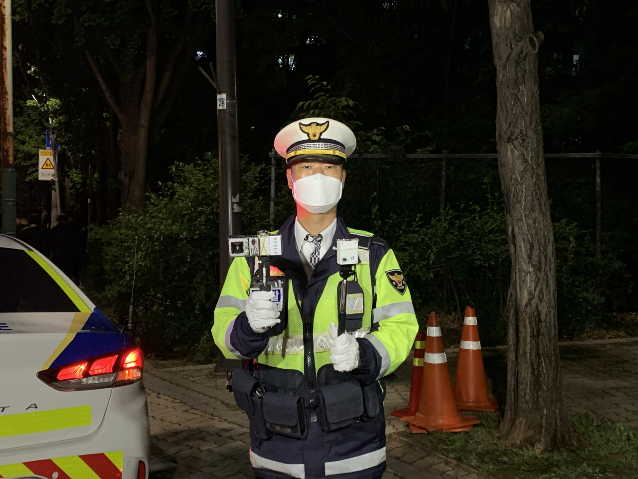 경찰이 양손에 음주운전 감지기를 들고 있다. 왼쪽은 기존에 사용하던 부는 방식의 감지기와 오른쪽은 비접촉식 감지기. 신주희 기자/ joohee@heraldcorp.com