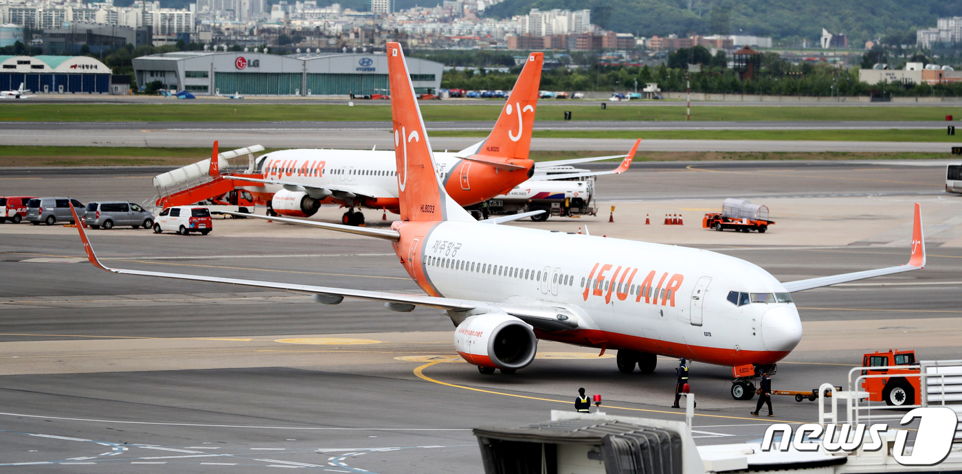 제주항공이 이스타항공에게 미지급금 해소를 포함해 인수합병을 위한 선결조건 이행 제시 마감일인 15일 김포공항에 계류되어 있는 제주항공 여객기의 모습.이스타 항공은 이날 자사 주식 약 60만주를 되찾기 위한 손해배상 청구 소송을 진행 중이라고 밝혔다.2020.7.15/뉴스1 © News1 정진욱 기자
