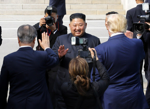 북한 김정은 국무위원장이 30일 오후 판문점에서 문재인 대통령과 도널드 트럼프 미국 대통령을 만난 뒤 군사분계선을 넘어 북으로 돌아가다 손을 흔들며 인사하고 있다. 연합뉴스