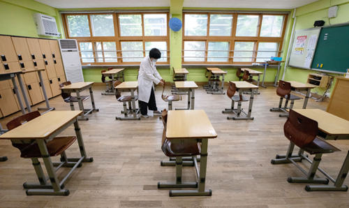 고등학교 등교 개학을 앞둔 지난 7일 서울 성동구 무학여자고등학교에서 한 교사가 개학 후 학생들이 밀집하는 것을 막기 위해 책상 간격을 벌리고 있다. 뉴스1