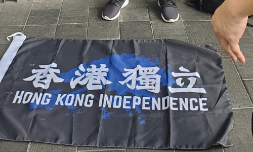 홍콩보안법 시행 후 처음으로 체포된 남성 앞에 ‘홍콩독립’이라고 적힌 플래카드가 바닥에 깔려 있다. 홍콩=연합뉴스