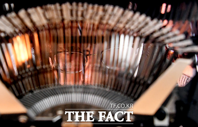 활자 너머로 수리에 열중하는 진지한 눈빛.