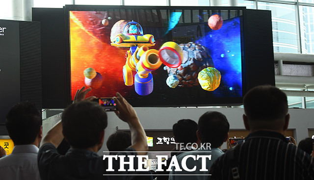 오버다임의 세계 최대 254인치 무안경 3D LED 디스플레이 시연 행사가 19일 오후 서울 용산구 서울역 대합실에서 열린 가운데 시민들이 3D 영상을 시청하고 있다. /이동률 기자