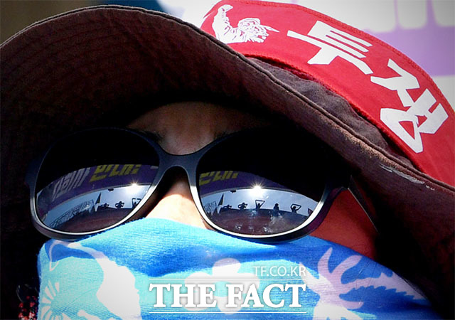 노조원의 선글라스에 비친 고공농성자들.