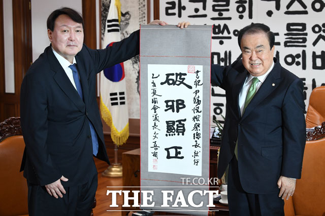 윤석열 검찰총장(왼쪽)이 7일 오전 서울 여의도 국회 의장실을 찾아 문희상 국회의장을 예방한 후 문 의장에게 '파사현정'이라고 쓰인 족자를 받고 있다./국회=남윤호 기자