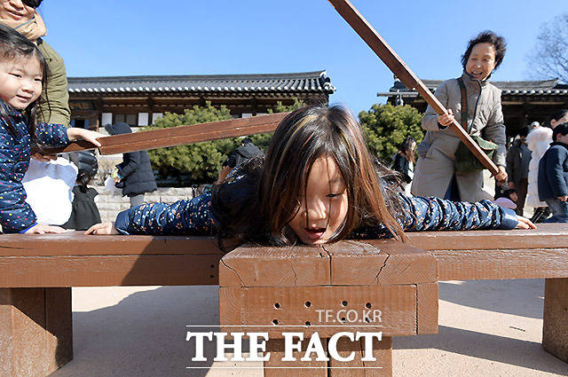 설 연휴인 26일 오후 서울 중구 남산골한옥마을에서 열린 '2020 남산골 설축제, 모두의 설' 행사에서 시민들이 '곤장 맞기 체험'을 하고 있다. /이효균 기자