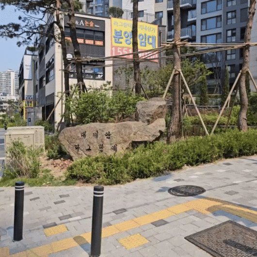 래미안 라그란데에서 1호선 외대앞역으로 내려오는 길 작은 사거리 모퉁이에 조경석이 설치돼 있다. 2025.05.27 [동영상=이효정 기자 ]